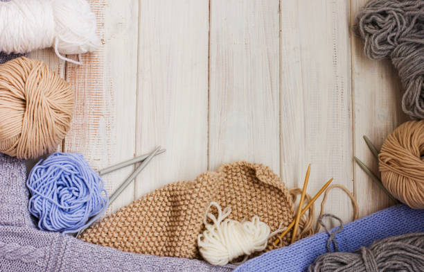 istock Knitting, needles and yarn on white wooden background. Copy space 857856752
