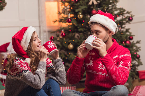 istock couple with cups at christmastime 857857382