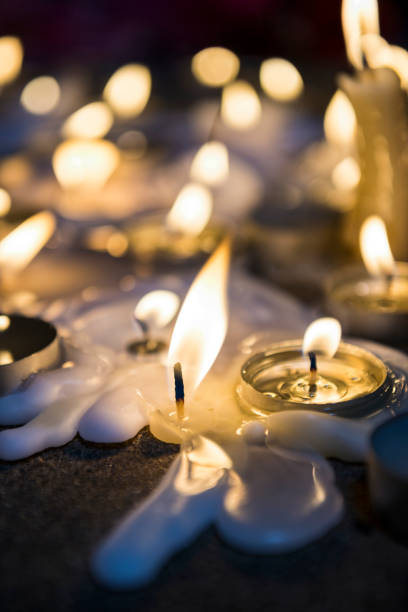 istock A close-up of a candle at a makeshift memorial vigil at night 857857430