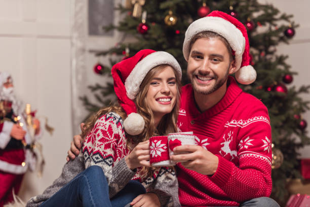 istock couple with cups at christmastime 857857490