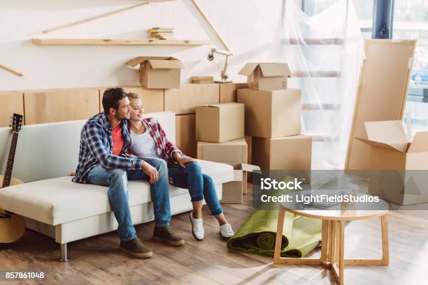 Couple Resting In New House Stock Photo - Download Image Now - Moving House, Couple - Relationship, Two People