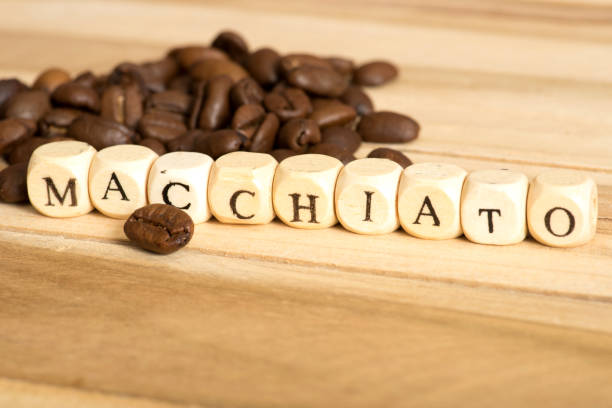 istock Coffee beans and coffee macchiato 857861250