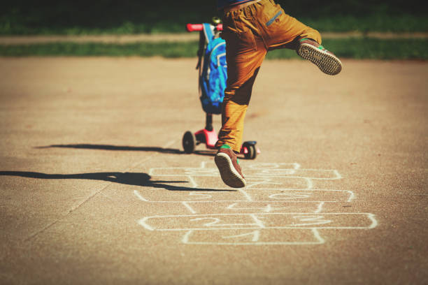 istock little boy playing hopscotch on playground 857861412