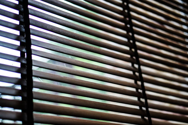 istock wood blind shade curtain and shadow 857865912