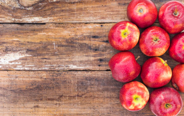 istock Fresh red apples on wooden table, top view 857865956