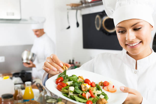 istock Cheerful female cook holding plate 857868830