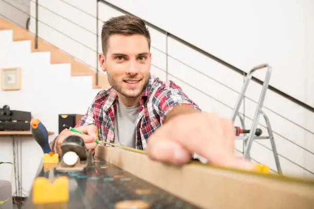Man working on wood planks for home-improvement