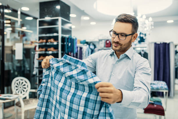istock Man is buying clothes 857876602
