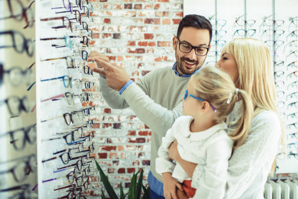istock Family in optics store 857877312