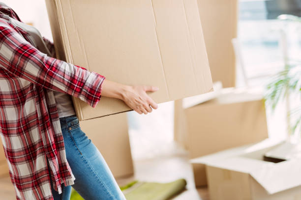 istock girl with cardboard boxes 857877942