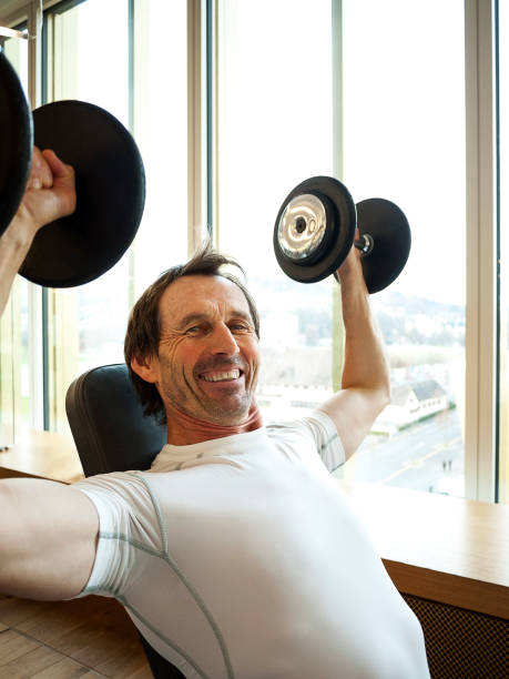 istock Mature Man Lifting Dumbbells 857888526