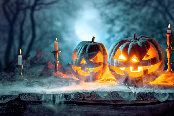istock Halloween pumpkins on blue background 857892364