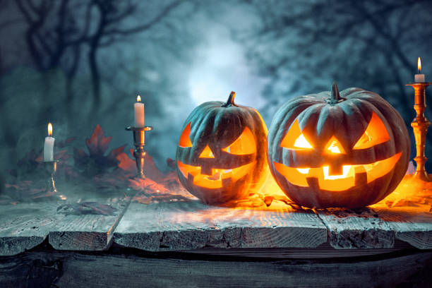 istock Halloween pumpkins on blue background 857894960