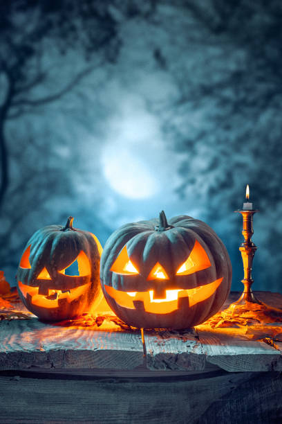 istock Halloween pumpkins on blue background 857895596