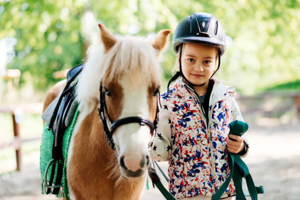 istock Young girl with her pony horse 857896534