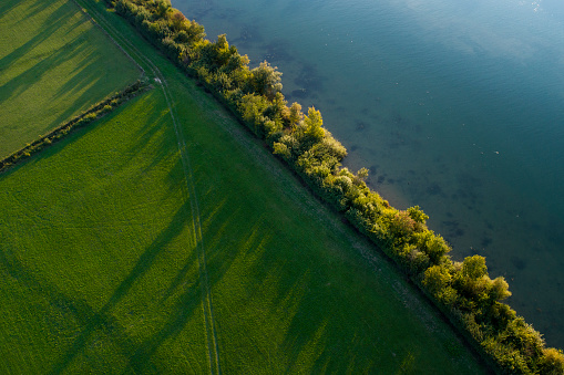 Riverbank and meadow - aerial view at dusk