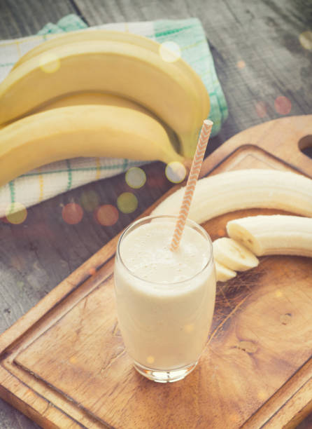 istock Banana smoothie on a rustic wooden table 857897604