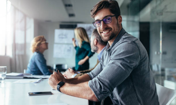 istock Businessman sitting in board room during presentation 857897930
