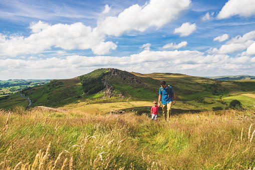 Photographer taking photos in the national park Peak District on the sunset in Summer