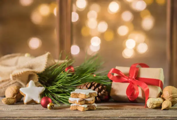 Photo of Christmas eve gift with decoration and festive lights background