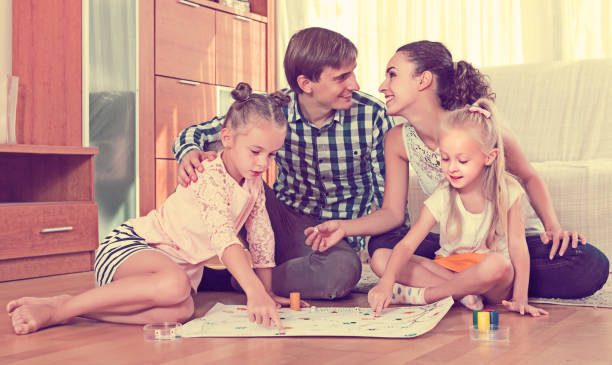 istock Family playing at board game 857912570