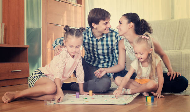 istock Family  playing at board game 857912572
