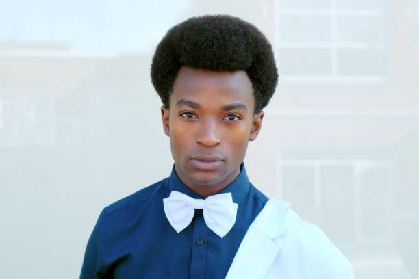 istock young man bow tie portrait white suit dark shirt 857912768