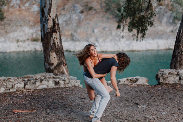 istock Woman embracing her boyfriend back playfully 857916696