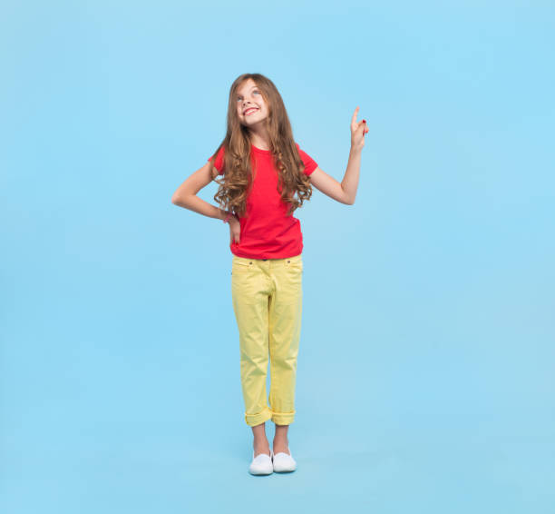 istock Dreaming girl pointing up 857923194