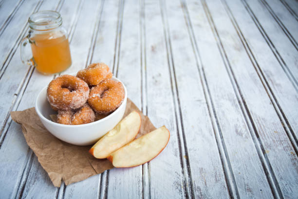 Savory Apple Cider Donuts Sweet and savory apple cider donuts on a table. apple juice photos stock pictures, royalty-free photos & images