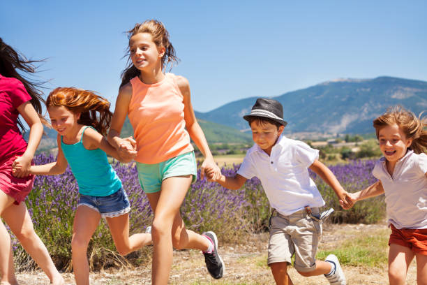 istock Happy children running together in lavender fields 857930952