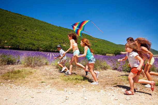 istock Happy children flying colorful kite in summer 857931122