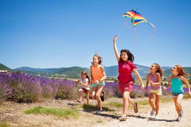 istock Kids flying kite running through lavender field 857931496