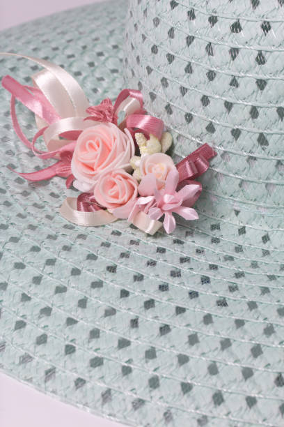 istock A broad-brimmed female hat is light green, with a buttonhole. Artificial flowers in the form of roses. 857932604