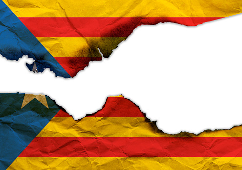 Scorched bandera de Cataluña aislada sobre fondo blanco, imagen de concepto sobre la situación política en España photo