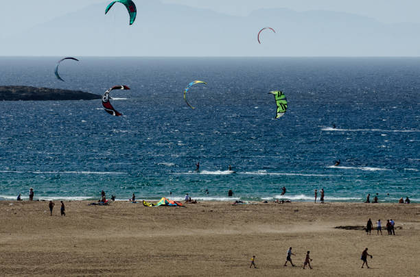 istock Sandy beach and the kitesurfers on the waves 857940884