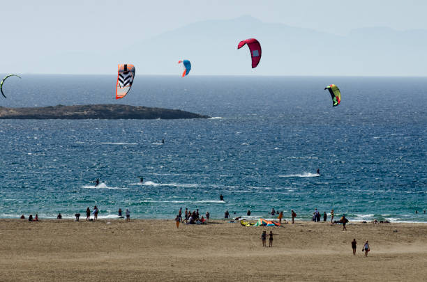 istock Sandy beach and the kitesurfers on the waves 857940990