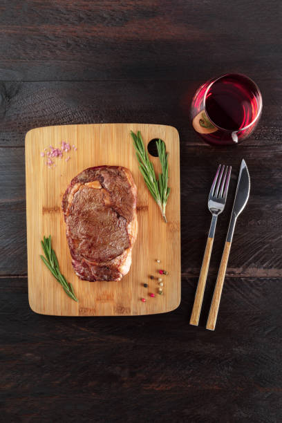 istock Cooked meat on rustic textures with seasoning and wine 857943292