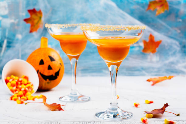 istock Autumn pumpkin martini cocktail with halloween decor 857943450