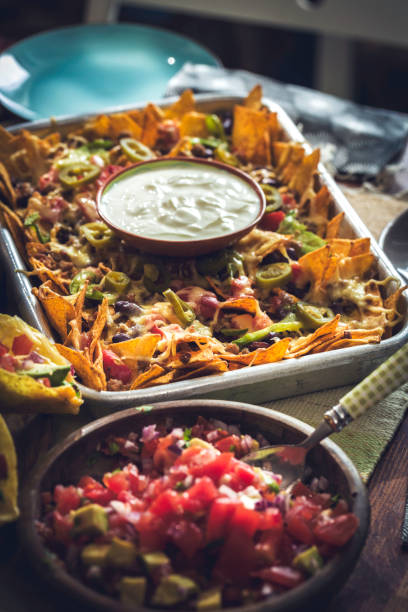 istock Baked Nachos Tortilla Chips with Salsa, Minced Meat and Jalapenos 857944154