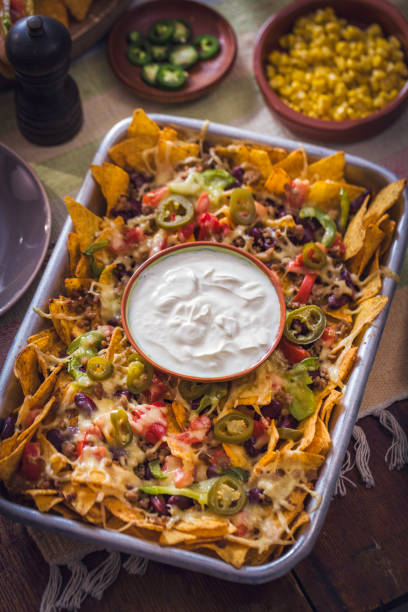 istock Baked Nachos Tortilla Chips with Salsa, Minced Meat and Jalapenos 857944172