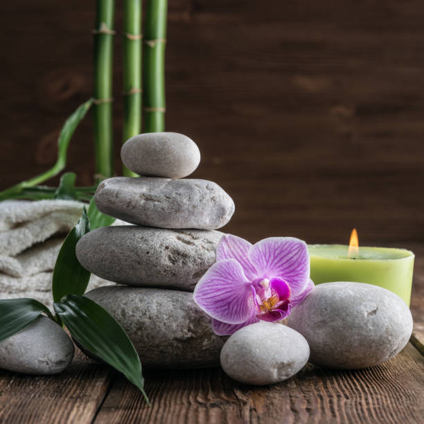 istock Stones hot stone, Orchid, bamboo and candle. Zen relaxation 857947400