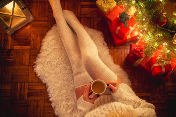 istock Young Woman Drinking Hot Coffee on Christmas Night 857951078