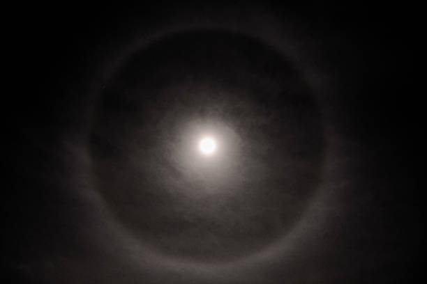 istock Full moon in a cloudy sky with halo 857954364