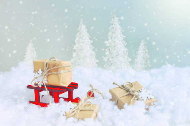istock Christmas card, red wooden sled wrapped gift box 857957920