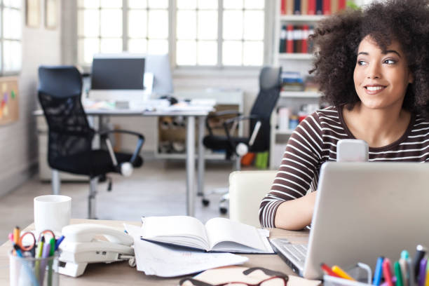 istock African woman with smart phone in modern workplace 857962162