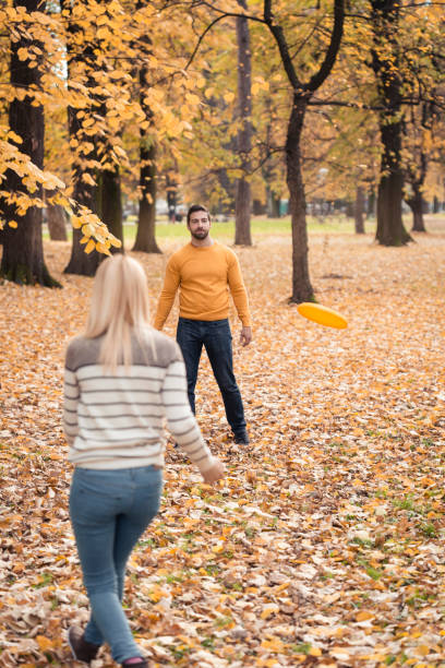 istock Young Couple Playing Frisbee 857966276