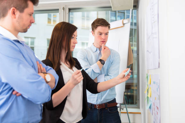 istock Colleagues With Adhesive Notes Standing In Office 857969350