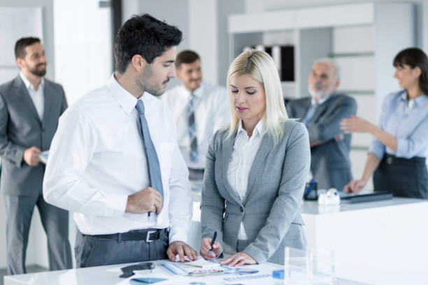 istock Man and woman working together in the office 857969950