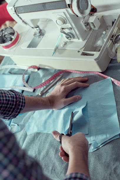 istock Close-up hands of male tailor Cutting Fabric 857976226